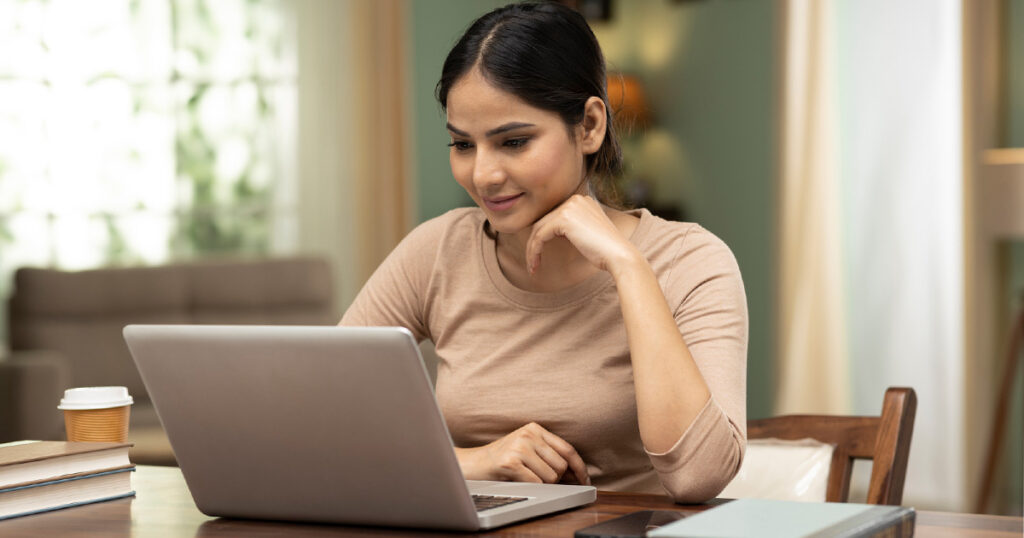 Young woman working on a laptop promoting wellness