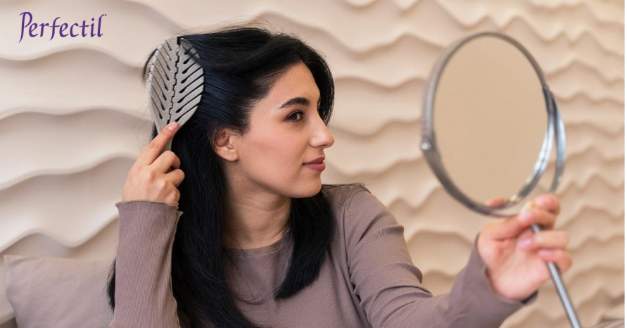 Young women combing her hair - perfectil hair care